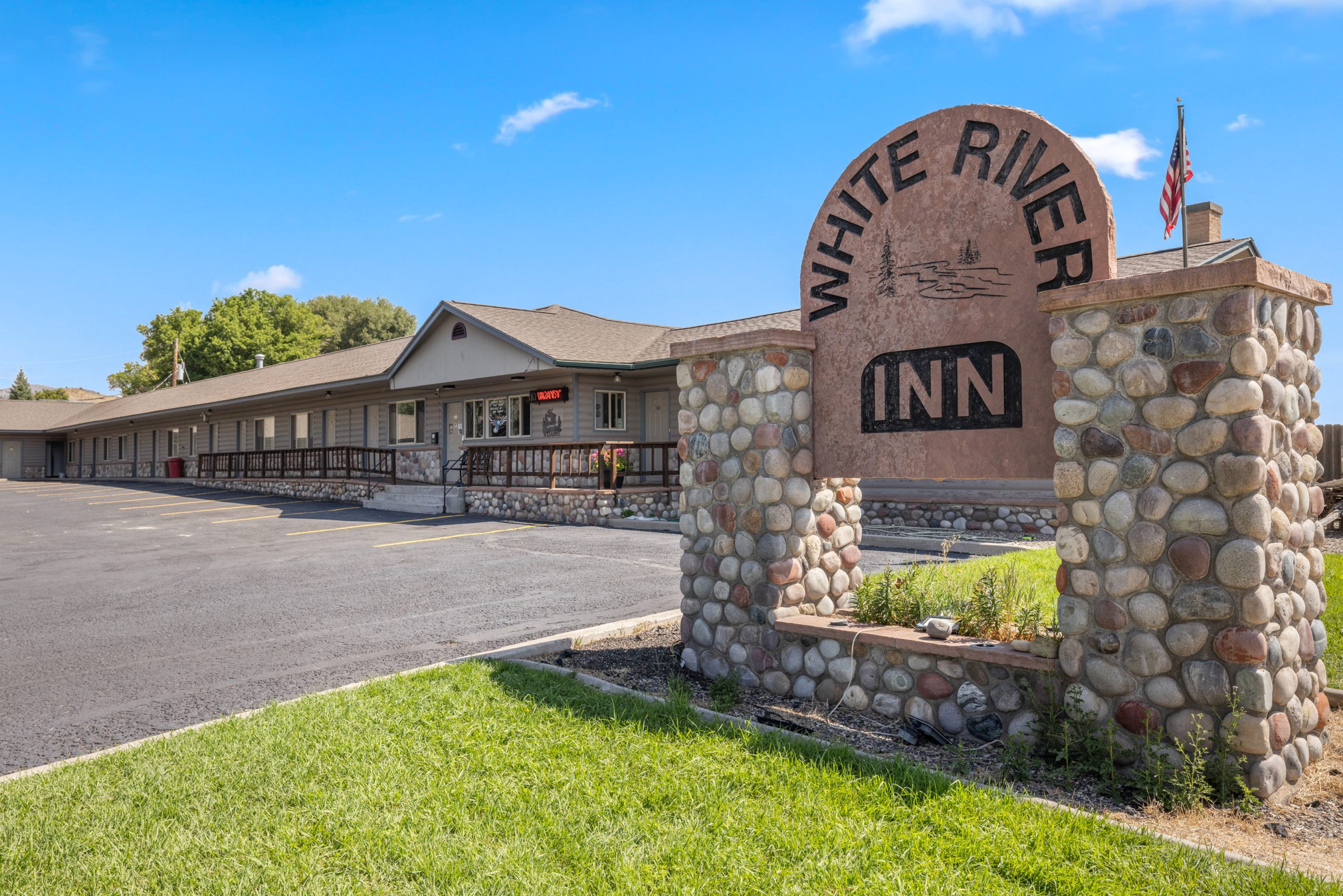The White River Inn stone entrance sign and guest room building on East Market Street in Meeker, Colorado